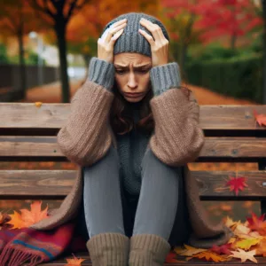 woman sitting on bench in pain