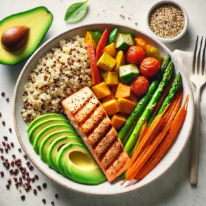 An image of a colorful balanced meal featuring quinoa roasted vegetables like sweet potatoes carrots and bell peppers alongside grilled salmon.